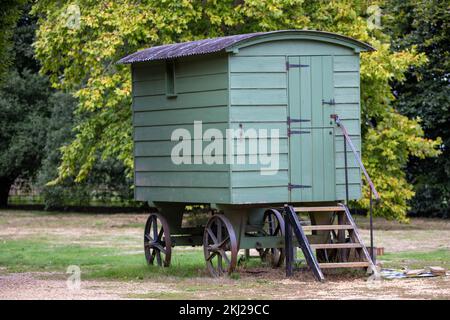 rustic old green shepherds hut in the english countryside Stock Photo