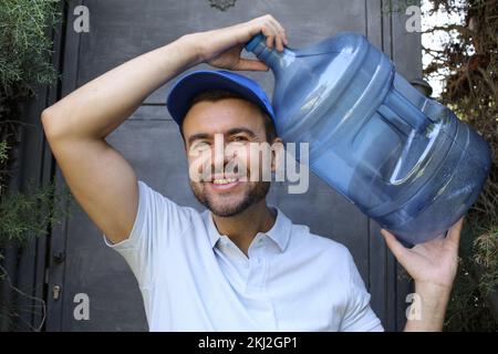 Water delivery guy all in blue outfit Stock Photo