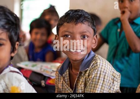 Happy school boy looking at camera in classroom Stock Photo