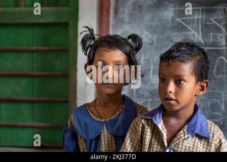 School Children's standing by the blackboard Stock Photo
