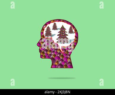 head made of ornaments, in brain christmas trees, creative holiday concept on green background Stock Photo