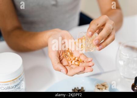 Nutritionist holding in hands omega 3 and vitamin D biologically active additives BAA. Dietary Supplements for correct the structure of human nutritio Stock Photo
