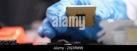 Engineer holds in hands powerful processor or board after repair Stock Photo