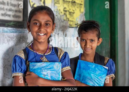 School Children's holding books standing at school Stock Photo