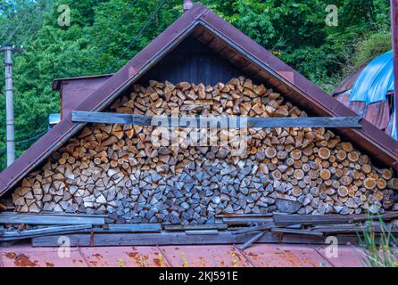 A pile of fire wood chopped and prepared for burning and heating the house in rural area in winter. Stock Photo