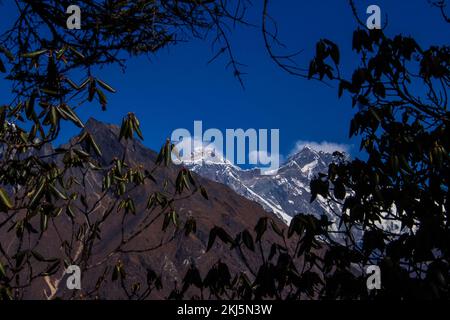 Namchebazaar, Khumjung Valley and Himalayas of Everest Base Camp Trekking in Solukhumbu, Nepal with Buddhist Prayer Flags and Wheel Stock Photo