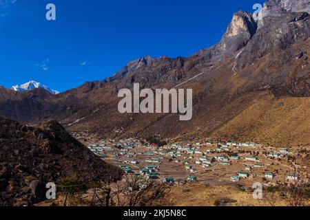 Namchebazaar, Khumjung Valley and Himalayas of Everest Base Camp Trekking in Solukhumbu, Nepal with Buddhist Prayer Flags and Wheel Stock Photo