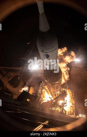 Kennedy Space Center, United States of America. 16 November, 2022. A wide angle remote view of the NASA Artemis I Space Launch System and Orion spacecraft as it lifts off from launch pad 39B at the Kennedy Space Center, November 16, 2022, in Cape Canaveral, Florida. After several failed attempts the un-crewed flight test is expected to lift off on November 16th.  Credit: Chris Coleman and Kevin Davis/NASA/Alamy Live News Stock Photo