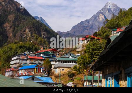 Namchebazaar, Khumjung Valley and Himalayas of Everest Base Camp Trekking in Solukhumbu, Nepal with Buddhist Prayer Flags and Wheel Stock Photo