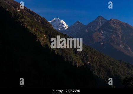 Namchebazaar, Khumjung Valley and Himalayas of Everest Base Camp Trekking in Solukhumbu, Nepal with Buddhist Prayer Flags and Wheel Stock Photo