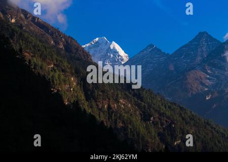 Namchebazaar, Khumjung Valley and Himalayas of Everest Base Camp Trekking in Solukhumbu, Nepal with Buddhist Prayer Flags and Wheel Stock Photo