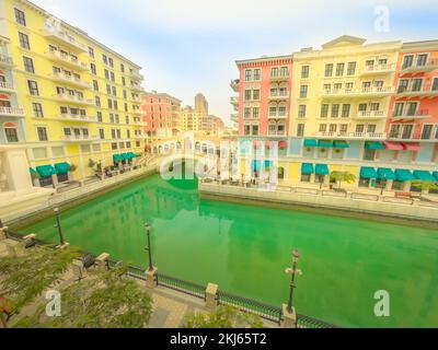 Aerial view of Venetian bridge on canals of picturesque and luxurious district of Doha. Scenic Venice at Qanat Quartier in the Pearl-Qatar, Persian Stock Photo