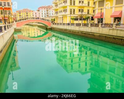 Scenic landscape of Venice at Qanat Quartier in the Pearl-Qatar, Persian Gulf, Middle East. Panoramic view of Venetian bridge reflecting on canals of Stock Photo