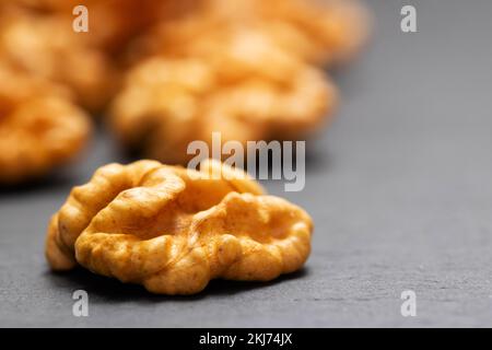 Walnuts. Walnut kernels on dark stone table. Vegetarian or healthy food Stock Photo