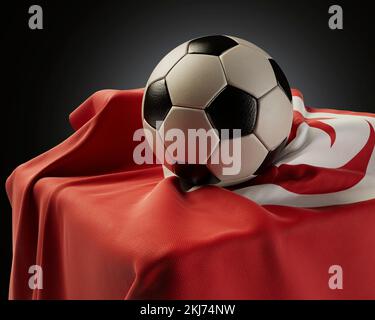 A regular soccer balls resting on a Tunisia flag draped over a plinth on an isolated studio background - 3D render Stock Photo