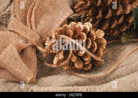 Zero waste Christmas concept. Fir cones and jute burlap decor, natural materials. Holiday, eco friendly concept Stock Photo