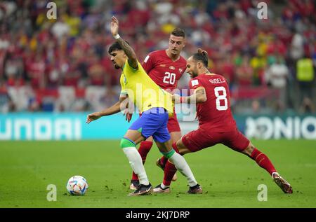 Brazil's Lucas Paqueta (left) and Serbia's Nemanja Gudelj battle for the ball during the FIFA World Cup Group G match at the Lusail Stadium in Lusail, Qatar. Picture date: Thursday November 24, 2022. Stock Photo