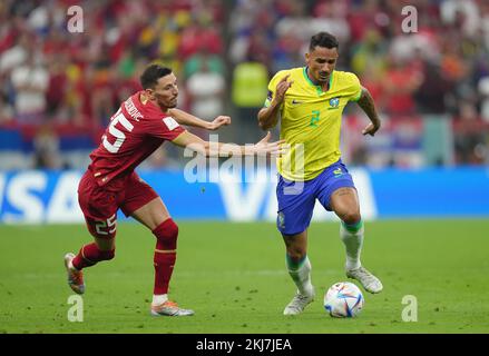 Serbia's Filip Mladenovic (left) and Brazil's Danilo in action during the FIFA World Cup Group G match at the Lusail Stadium in Lusail, Qatar. Picture date: Thursday November 24, 2022. Stock Photo