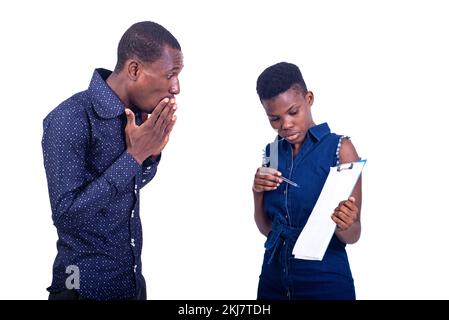 portrait of a shocked businessman looking at document on clipboard that woman is showing him. Stock Photo