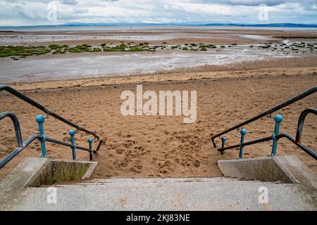 Concrete steps from Promenade to sandy beach Stock Photo