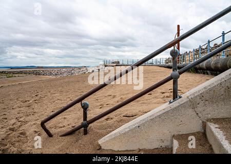 Concrete steps from Promenade to sandy beach Stock Photo