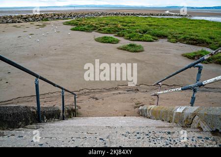 Concrete steps from Promenade to sandy beach Stock Photo