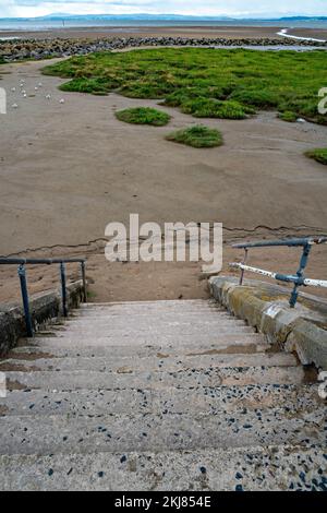 Concrete steps from Promenade to sandy beach Stock Photo
