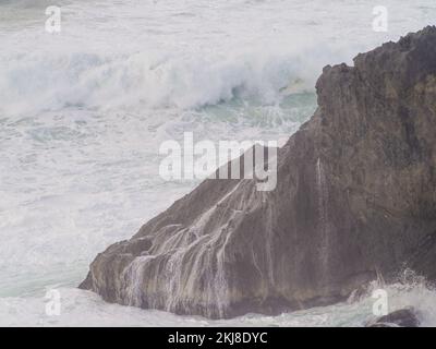 Big rock in the ocean. Raging waves crash against the rock. Storm, element. Beautiful seascape. Monochrome image. Ecology, fresh air, tourism, travel, Stock Photo