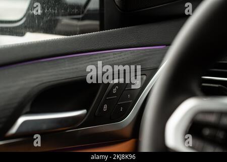 Car door lock unlock button close up. Modern car door lock. Door control panel in a new car. Stock Photo