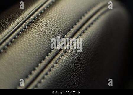 High angle view of modern car fabric seats. Close-up car seat texture and interior details. Detailed image of a car pleats stitch work. Leather seats. Stock Photo
