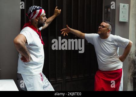 Two pizza makers having a discussion in their break time. Stock Photo