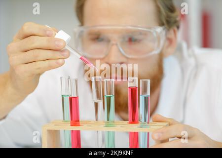 close view of male scientist using pipette Stock Photo