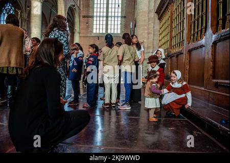 Boy scouts and children are seen getting ready before the ceremony. After the pilgrims left England to escape the established Anglican Church and before they landed on Plymouth Rock, they arrived in Leiden, The Netherlands where they lived for 11 years. Thanksgiving holds a special significance for the Dutch and every year in Leiden, the annual Thanksgiving Day Service at the historic Pieterskerk in Leiden is a celebration of the history of the pilgrims and their connection to Holland. The pilgrims recorded their births, marriages, and deaths in the Pieterskerk, and lived in the surrounding ne Stock Photo