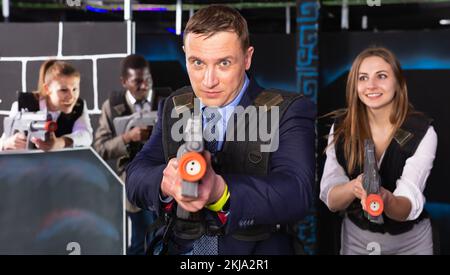 Man holding laser gun and playing laser tag Stock Photo - Alamy