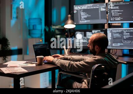 Programer compiling coding language on laptop, dealing with chronic impairment and working at night. Programming data script on terminal window, developing new server algorithms. Stock Photo