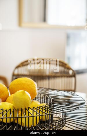 Decorative centerpiece made of black wire filled with ripe citrus Stock Photo