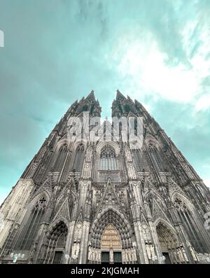 Vertical low angle shot of the Cologne Cathedral facade under the clear ...