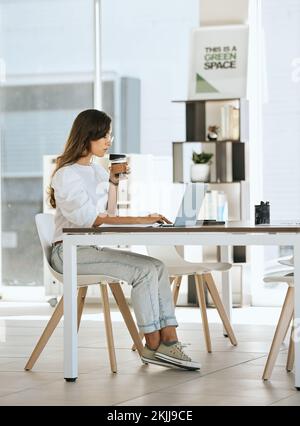Laptop, coffee and business woman in office drinking espresso or cappuccino. Computer, tea and female from Canada with hot beverage while typing Stock Photo