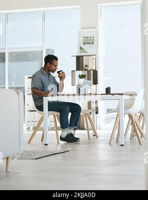Black man, coffee drinking and office with laptop, table and thinking in marketing startup business. Man, drink espresso or tea at desk with computer Stock Photo