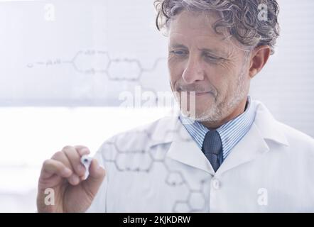 Male scientist working out a formula Stock Photo - Alamy