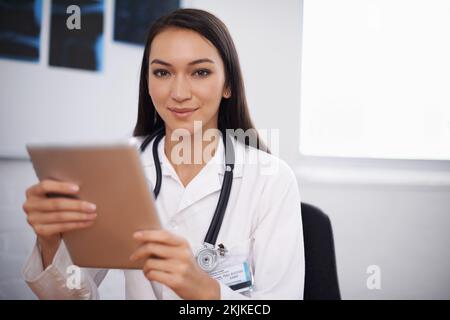 All the medical research at her fingertips. Portrait of a young doctor using a digital tablet. Stock Photo