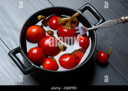 Potted cherry peppers in vinegar, chilli, paprika Stock Photo