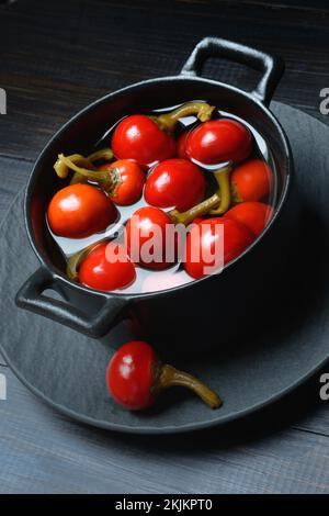 Potted cherry peppers in vinegar, chilli, paprika Stock Photo