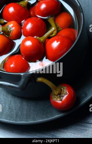 Potted cherry peppers in vinegar, chilli, paprika Stock Photo