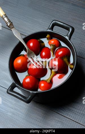 Potted cherry peppers in vinegar, chilli, paprika Stock Photo