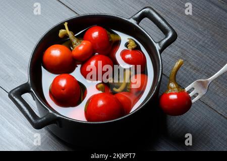 Potted cherry peppers in vinegar, chilli, paprika Stock Photo