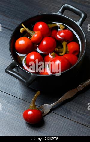 Potted cherry peppers in vinegar, chilli, paprika Stock Photo