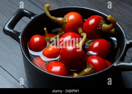 Potted cherry peppers in vinegar, chilli, paprika Stock Photo