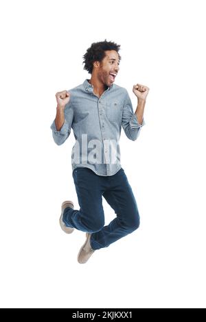 Joy is not in things but in us. Studio shot of a handsome man jumping excitedly isolated on white. Stock Photo