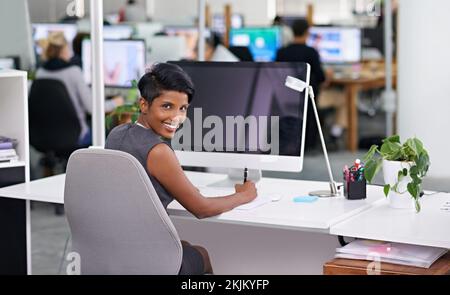 Working on my latest project. an attractive young woman businesswoman in her office. Stock Photo
